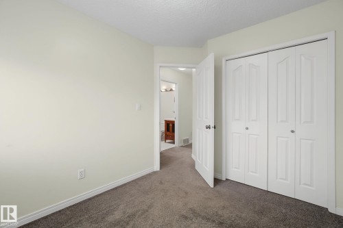 Room featuring neutral wall paint, white trim, and gray carpet flooring - 4259 29 Avenue, Edmonton, AB 