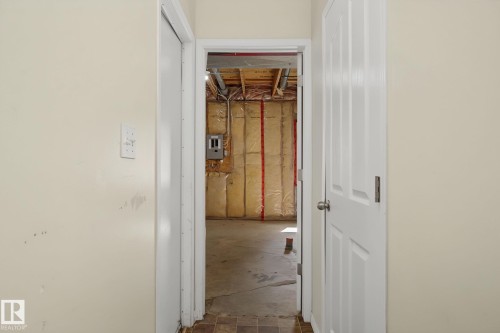 Unfinished basement space with exposed ceiling joists, insulation, and concrete flooring - 4259 29 Avenue, Edmonton, AB 