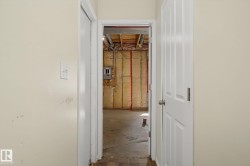 Unfinished basement space with exposed ceiling joists, insulation, and concrete flooring - 