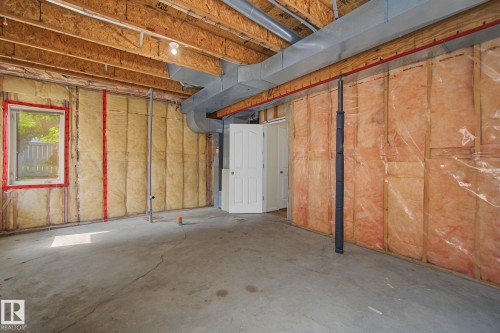 Unfinished basement featuring exposed wood joists, concrete flooring, and insulated walls - 4259 29 Avenue, Edmonton, AB 