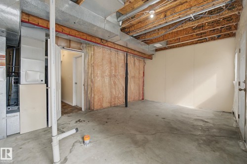 Spacious unfinished basement offering concrete flooring, exposed ceiling joists, and open mechanicals - 4259 29 Avenue, Edmonton, AB 