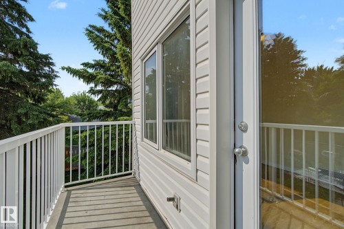 Private balcony featuring white vinyl railing and a glass paneled door - 4259 29 Avenue, Edmonton, AB 