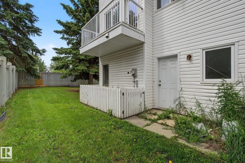 Spacious grass area bordered by a privacy fence and mature trees - 4259 29 Avenue, Edmonton, AB 