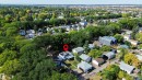 Residential property featuring solar panels on the roof and a surrounding neighborhood with mature trees - 12005 40 St, Edmonton, AB 