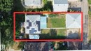 Aerial view showcasing the primary residence, a detached garage, and a spacious backyard - 12005 40 St, Edmonton, AB 