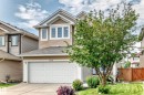 Two-story residential exterior featuring beige horizontal siding and vertical panel accents - 1330 114B Street, Edmonton, AB 