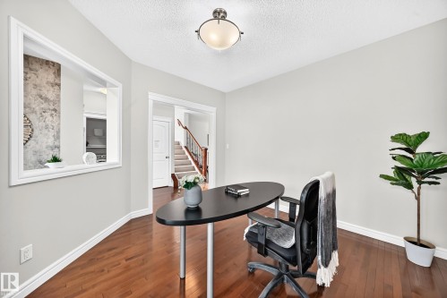 Bright interior space with wood-finish flooring and neutral wall tones - 1330 114B Street, Edmonton, AB 