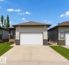 Ranch-style exterior featuring light-toned siding and stone veneer accents - 45 Willow Wood Lane, Stony Plain, AB 