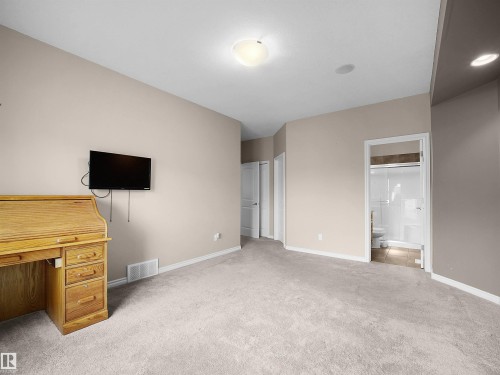 Spacious carpeted room featuring a white ceiling, recessed lighting, and a neutral wall color - 45 Willow Wood Lane, Stony Plain, AB 