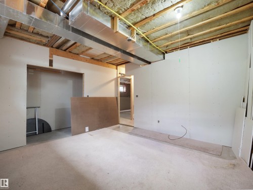 Unfinished basement space featuring exposed ceiling joists, insulation, and ductwork - 45 Willow Wood Lane, Stony Plain, AB 