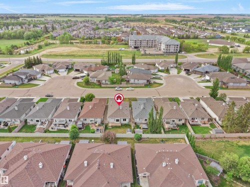 Aerial view of a residential neighborhood with single-family homes and an apartment building - 45 Willow Wood Lane, Stony Plain, AB 