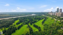 Expansive golf course setting featuring manicured greens and mature trees - 