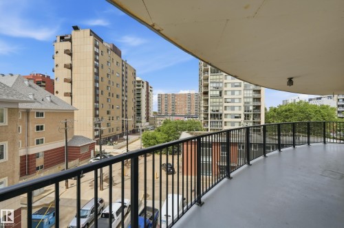 Expansive curved balcony featuring a black metal railing and concrete flooring - 504 11710 100 Avenue, Edmonton, AB 