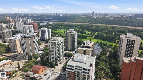 Urban landscape featuring multiple high-rise buildings, extensive green spaces, and a winding river - 504 11710 100 Avenue, Edmonton, AB 