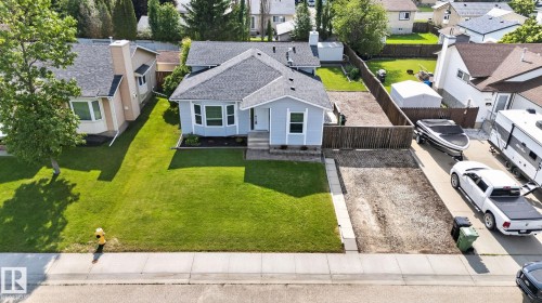 Light blue exterior with a dark shingle roof and white trim - 3218 41 Street, Leduc, AB 