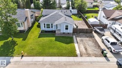 Light blue exterior with a dark shingle roof and white trim - 