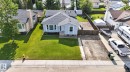 Light blue exterior with a dark shingle roof and white trim - 3218 41 Street, Leduc, AB 