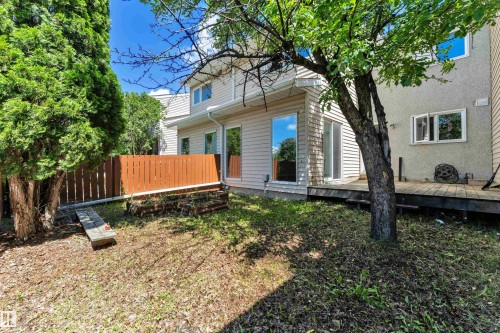 Expansive backyard featuring a wood deck, mature trees, and a privacy fence - 6632 36A Avenue, Edmonton, AB 