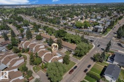Aerial perspective showcasing a residential development with multiple units and brown shingle roofs - 