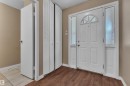Entryway featuring a paneled door with an arched transom window and frosted sidelights - 6632 36A Avenue, Edmonton, AB 