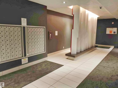 Lobby area featuring white tile flooring and a contemporary architectural room divider - 2505 10410 102 Avenue, Edmonton, AB 