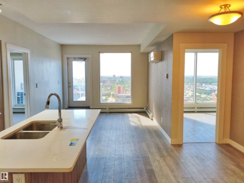 Kitchen island with a double basin stainless steel sink and gooseneck faucet - 2505 10410 102 Avenue, Edmonton, AB 