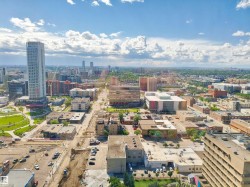 Expansive urban landscape featuring a diverse architectural mix including modern high-rises and established commercial buildings - 
