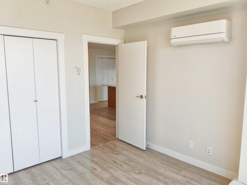 Room featuring light wood-finish flooring, white baseboards, and neutral wall paint - 2505 10410 102 Avenue, Edmonton, AB 