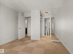 Room featuring checkered carpet flooring, light gray walls, white baseboards, and a white ceiling - 