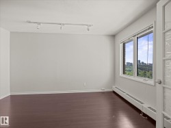 Bright interior space featuring a large window with city and green space scenery - 