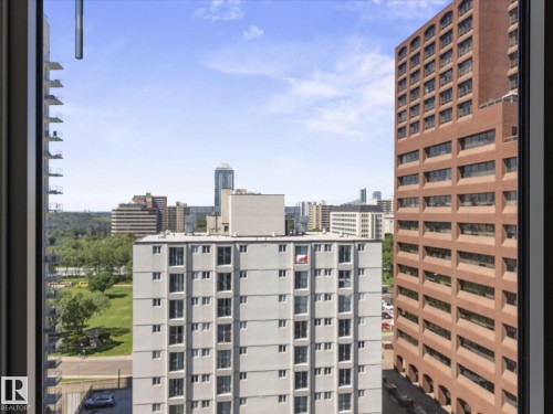 Expansive urban scenery featuring diverse building architecture, mature trees, and open green spaces - 1601 9725 106 Street, Edmonton, AB 