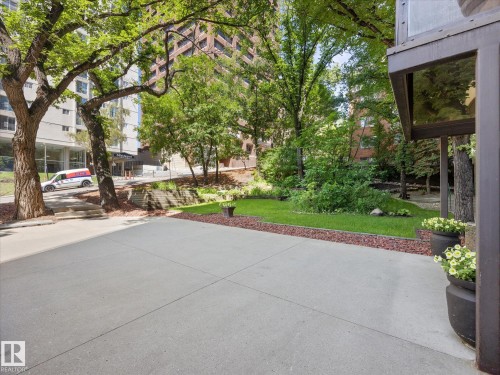 Paved patio area with surrounding green space - 1601 9725 106 Street, Edmonton, AB 