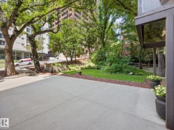 Paved patio area with surrounding green space - 