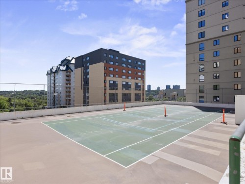 Rooftop tennis court with green playing surface and white line markings - 1601 9725 106 Street, Edmonton, AB 