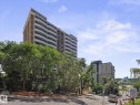 Mid-rise building featuring a brown and white facade with multiple curved balconies - 1601 9725 106 Street, Edmonton, AB 