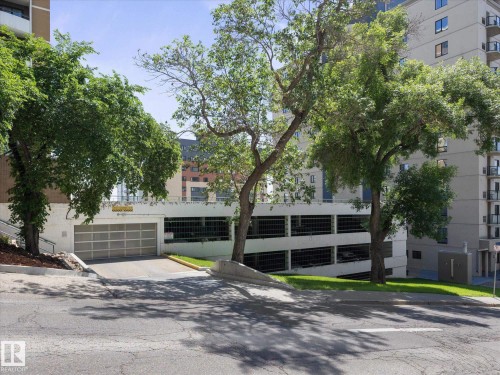 Multi-level parking garage featuring a ground-level entrance with a roll-up door - 1601 9725 106 Street, Edmonton, AB 