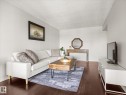 Spacious living area featuring rich wood-finish flooring - 1601 9725 106 Street, Edmonton, AB 