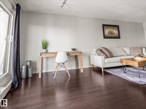 Rich dark wood-finish flooring throughout the living space - 1601 9725 106 Street, Edmonton, AB 