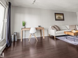 Rich dark wood-finish flooring throughout the living space - 