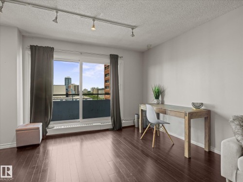 Expansive sliding glass doors open to a balcony, offering city scenery - 1601 9725 106 Street, Edmonton, AB 