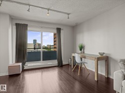 Expansive sliding glass doors open to a balcony, offering city scenery - 