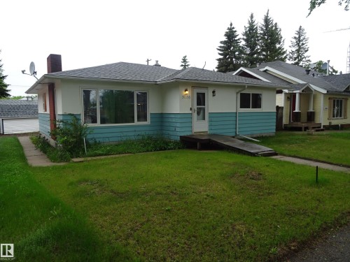 Ranch-style residence featuring a two-tone exterior with white and teal siding - 5036 52 Street, Andrew, AB 