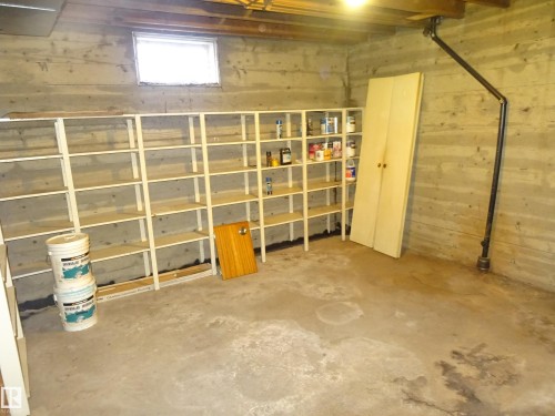 Concrete foundation walls featuring a small window - 5036 52 Street, Andrew, AB 