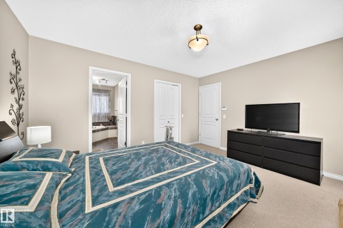 Carpeted room with a ceiling-mounted light fixture and neutral wall tones - 8507 179 Avenue, Edmonton, AB 