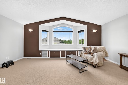 Bay window with integrated storage cabinetry and an arched central window - 8507 179 Avenue, Edmonton, AB 
