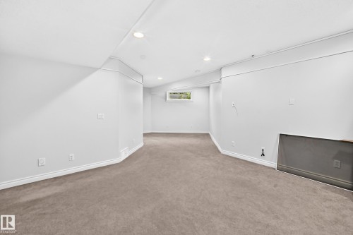 Finished lower level featuring recessed lighting, a window, and neutral carpeting - 8507 179 Avenue, Edmonton, AB 
