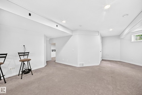 Expansive room featuring light gray carpeting and white painted walls - 8507 179 Avenue, Edmonton, AB 