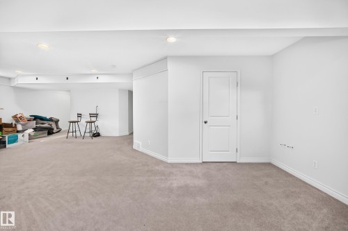 Spacious interior featuring neutral carpeting and white painted walls - 8507 179 Avenue, Edmonton, AB 