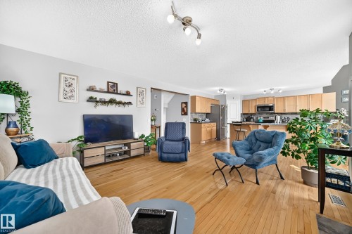 Open-concept living area featuring wood-finish flooring - 8507 179 Avenue, Edmonton, AB 