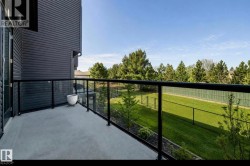 Outdoor balcony with a smooth concrete surface and black frame glass railings - 